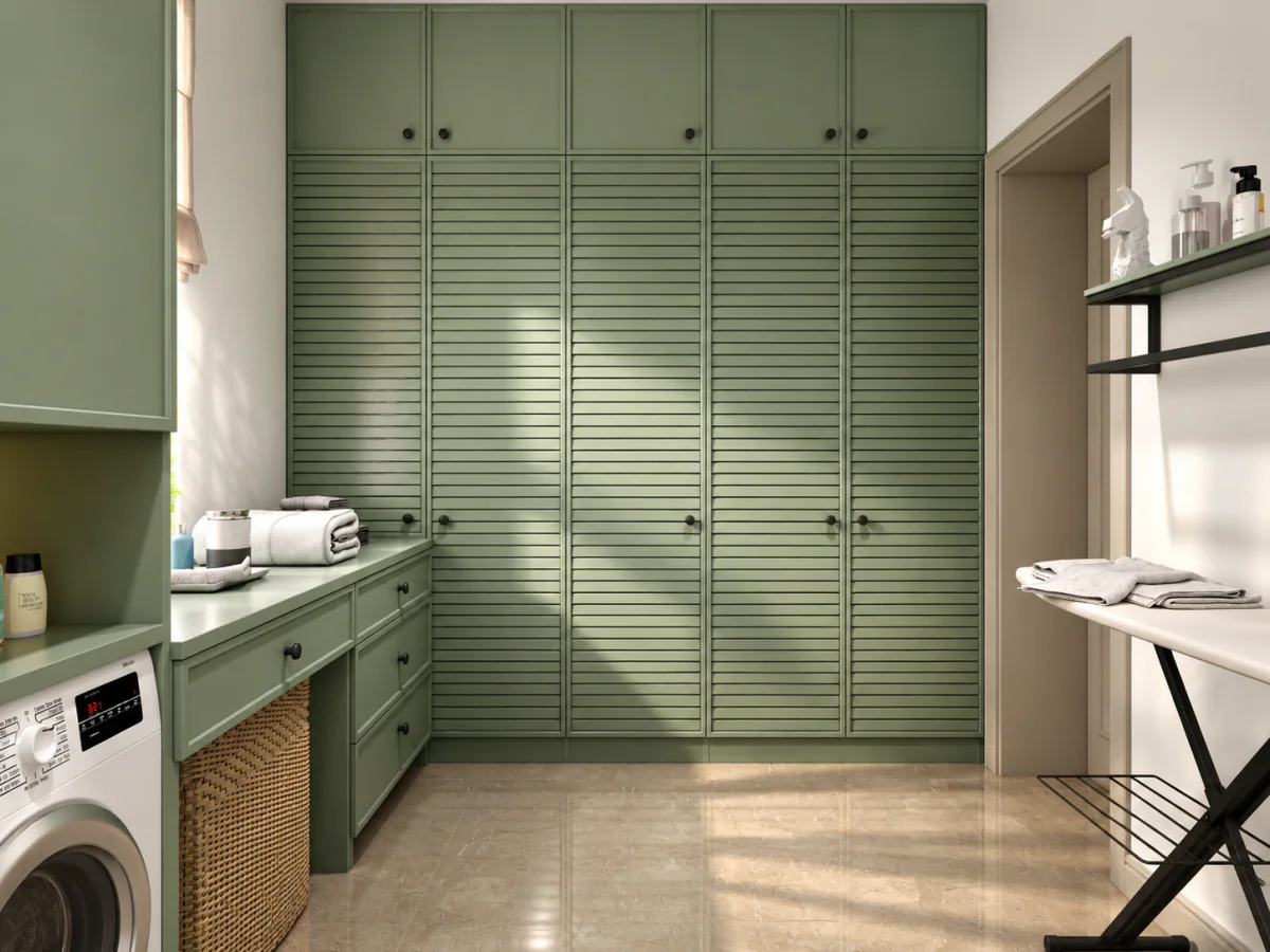 Laundry room with tall green cabinets and a folding worktop
